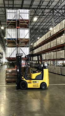 Cornerstone Systems forklift operating in Memphis warehouse facility with stacked pallets